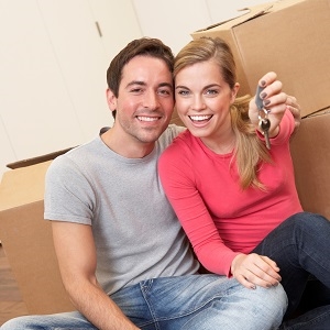 young couple with condo keys moving in